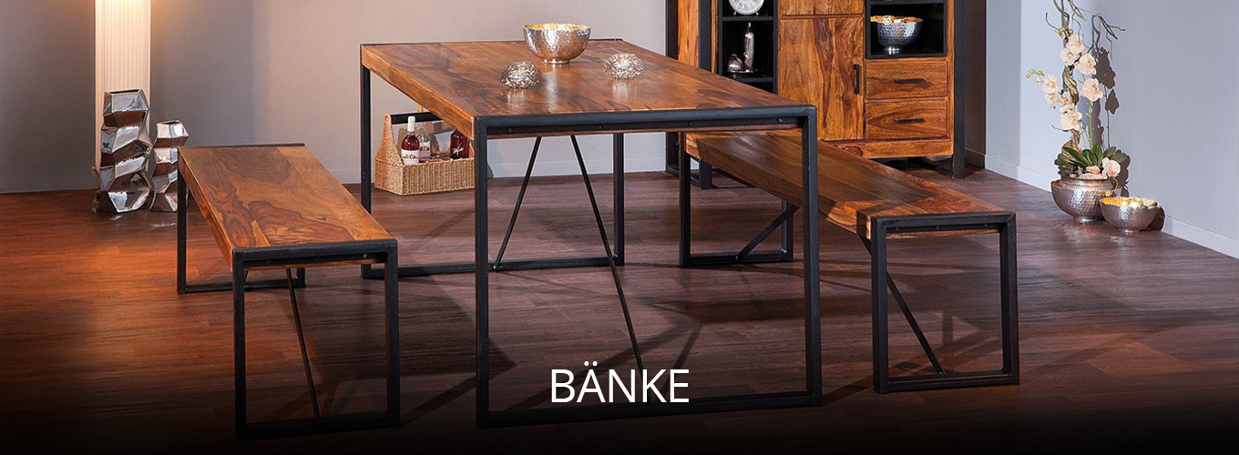 Massivholz-Esstisch mit zwei Sitzbänken im Industrial-Stil, kombiniert mit schwarzem Metallgestell und passenden Wohnaccessoires im Essbereich.
