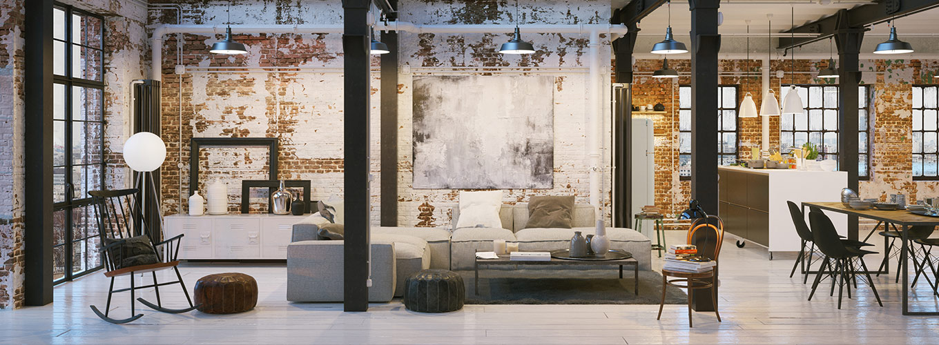 Loft Ambiente mit gob verputzter Backstein-Mauer, anthrazitfarbenen Stahlstützen, die den Raum in Wohn- Ess- und Küchenbereich gliedern