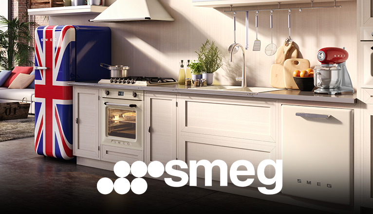 smeg bei Moebel-Shop – Helle Landhausküche in offenem Loft, ausgestattet mit SMEG Küchengeräten. Roter Toaster und rote Küchenmaschine setzen Akzente, am Rand steht ein Retro-Kühlschrank mit britischer Flagge.