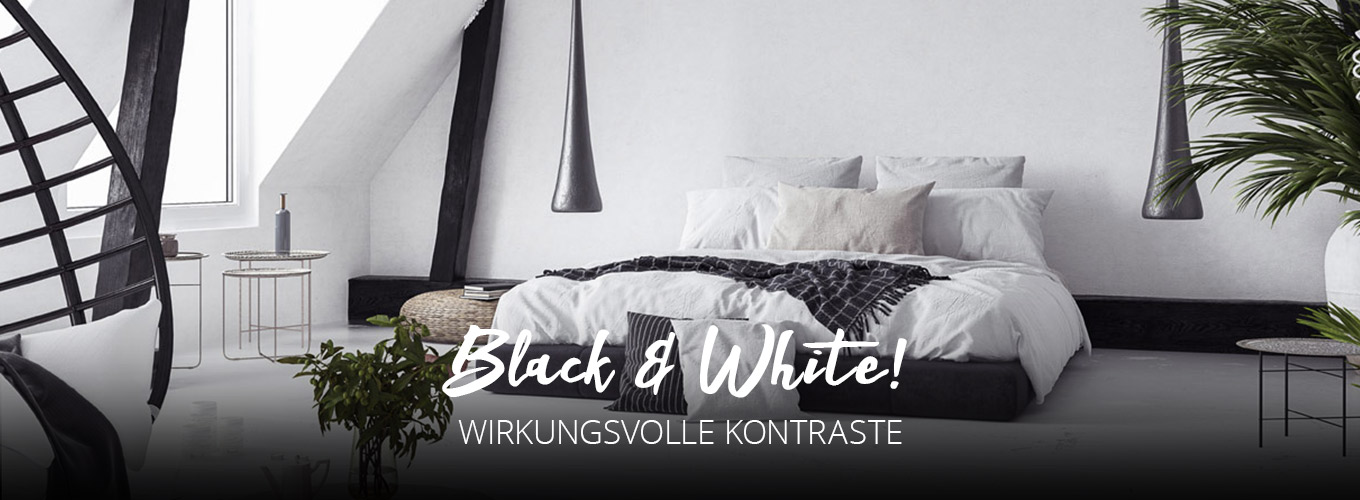 Black & White - Wirkungsvolle Kontraste - Modernes Schlafzimmer mit bodentiefem schwarzen Bett Schwarz-Weiß gehaltenen Dekorations-Elementen und dunkelgrünen Pflanzen